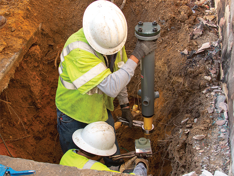 Gas Construction Technicians David Lanzi and Cameron Stephenson prepare the base for a new gas meter. Photo by NICHOLAS SAKELARIS