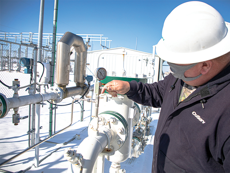Gas System Operations Technician Andy Gossett monitors a regulator station during cold weather. Photo by  KEN OLTMANN