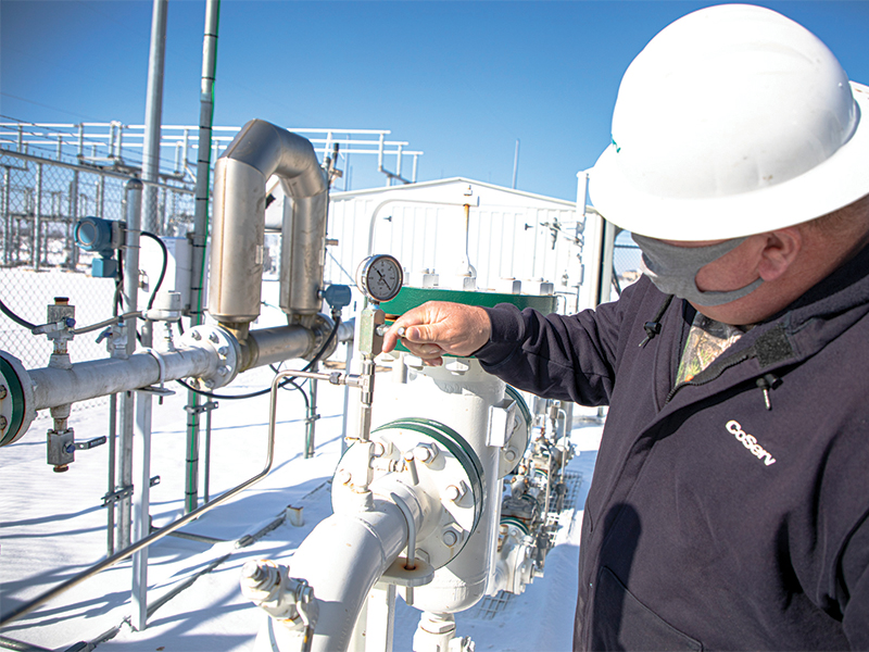 Gas System Operations Technician Andy Gossett monitors a regulator station during cold weather. Photo by KEN OLTMANN