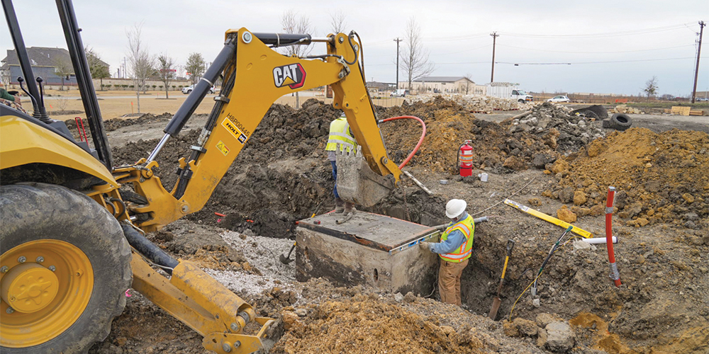 Contractors install a pulling vault for the high-voltage electricity that will serve the Lakes at Legacy development in Prosper. Photos by BRIAN ELLEDGE