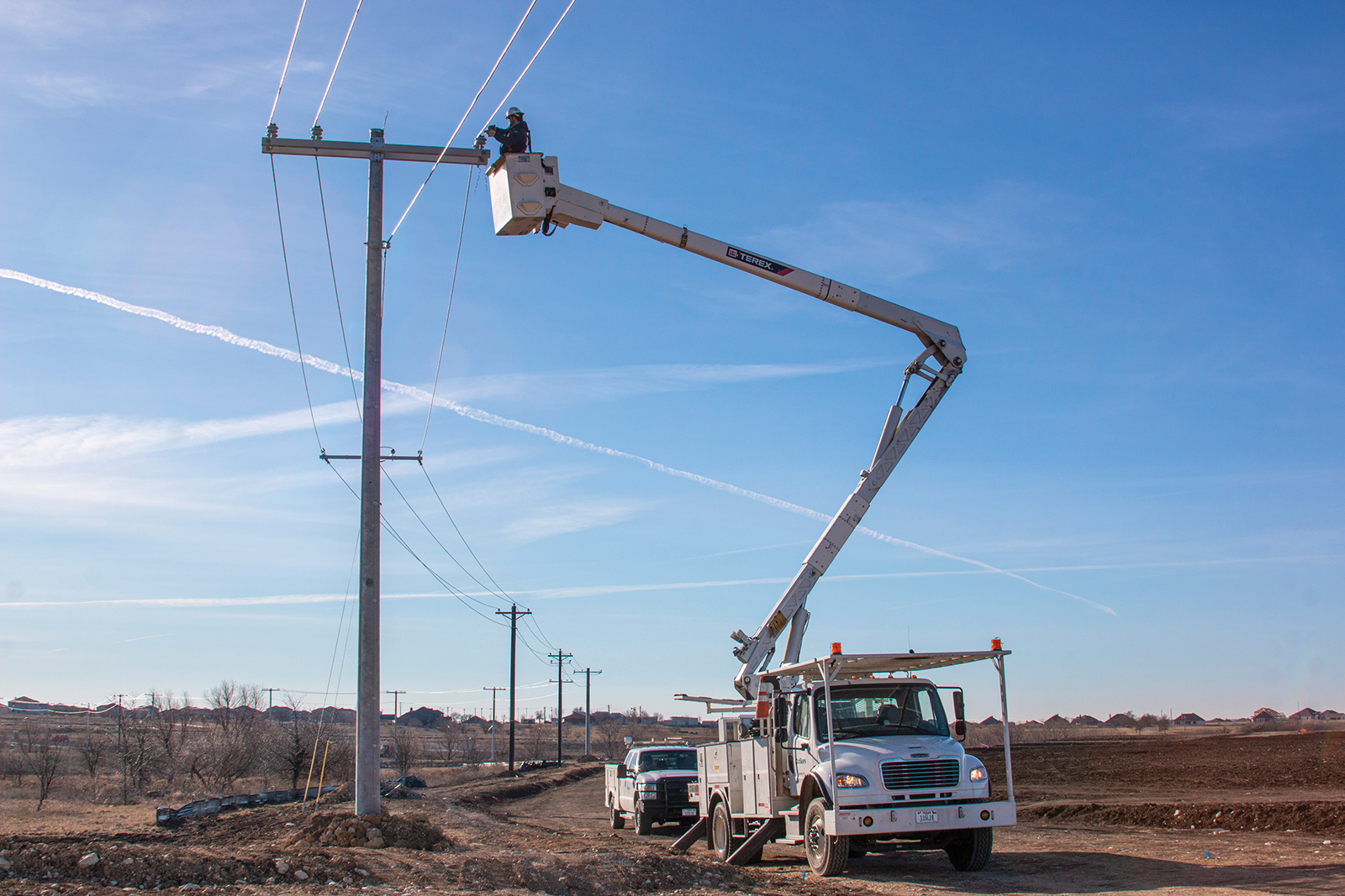 CoServ Lineman Bryce Clopton installs new power lines for the Big Sky developement in Ponder. Photo by NICHOLAS SAKELARIS
