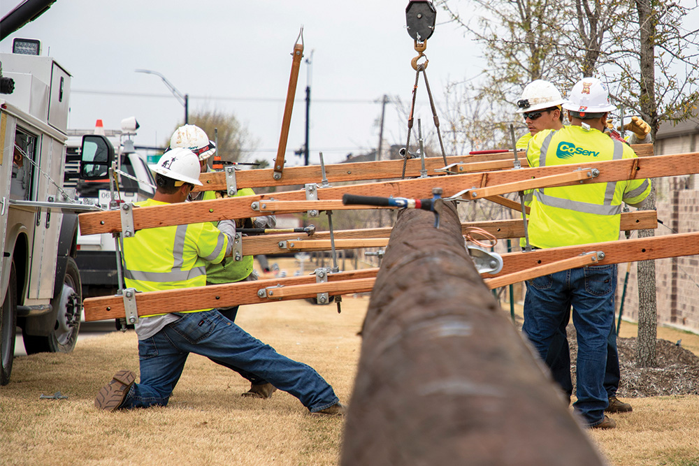 Teamwork is essential when installing a new pole.  Photo by KEN OLTMANN