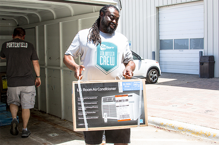 CoServ’s Energy Education Specialist Alphonso Williams drops off air conditioners at Christian Community Action.