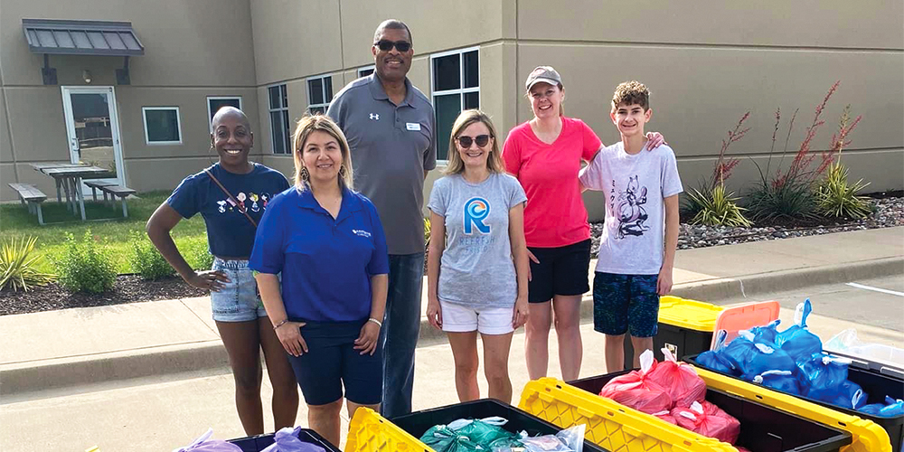 Left to right: Carolee Moore, Paula Perez, CoServ Electric District 4 Director Mark Rutledge, Anja Newbury, Christy Larkin and Owen Larkin helped distribute hygiene items to children who needed them. Photo by Refresh Frisco