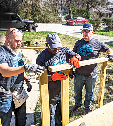 RIGHT: CoServ veterans Scott Grass (left) and Conan Tearney (right) have led the company's volunteer efforts for the Texas Ramp Project for many years. Photo by NICHOLAS SAKELARIS