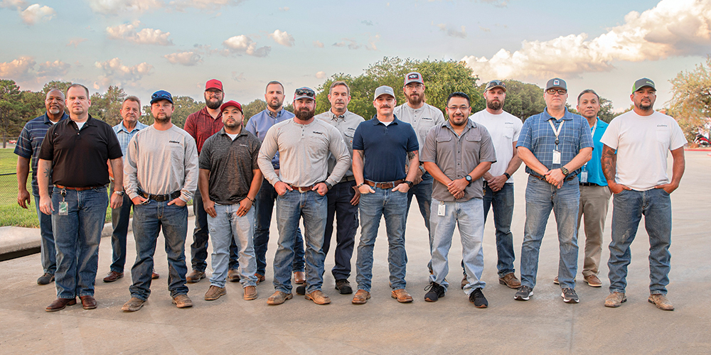 This group photo features 16 of the 36 veterans who work at CoServ.