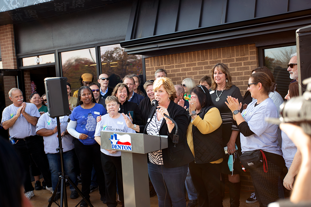 Executive Director Wendy McGee and the team at Our Daily Bread gather for a round of applause at the ribbon cutting ceremony for the nonprofit's new facility.