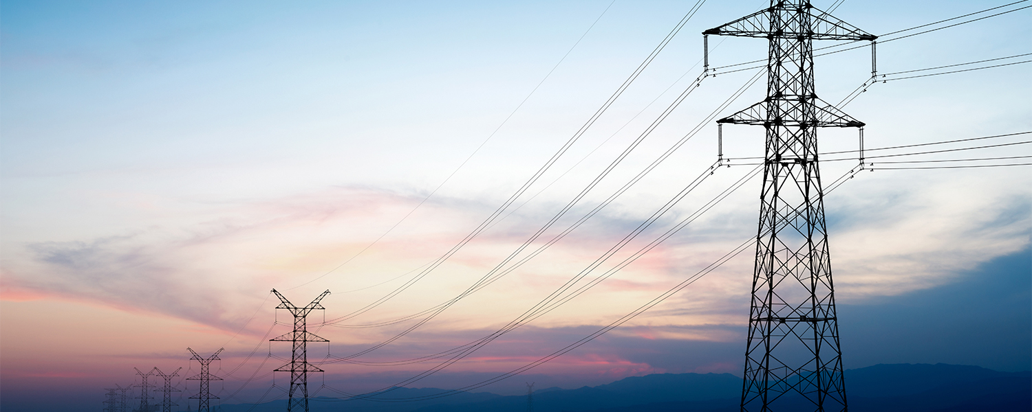 Pylon and transmission power line in sunset