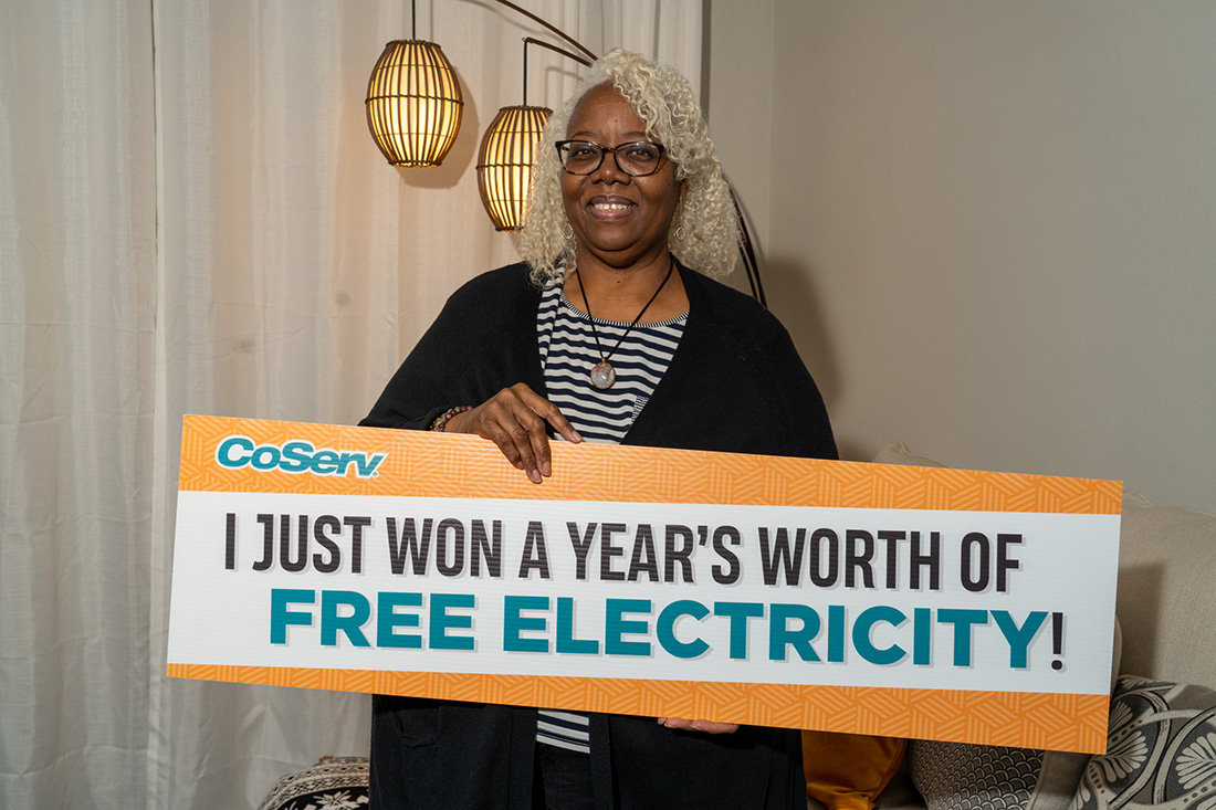 Winner of CoServ's Free Year of Electricity ($3,600 value) Cheryl Dixon in her apartment in Frisco, Texas.