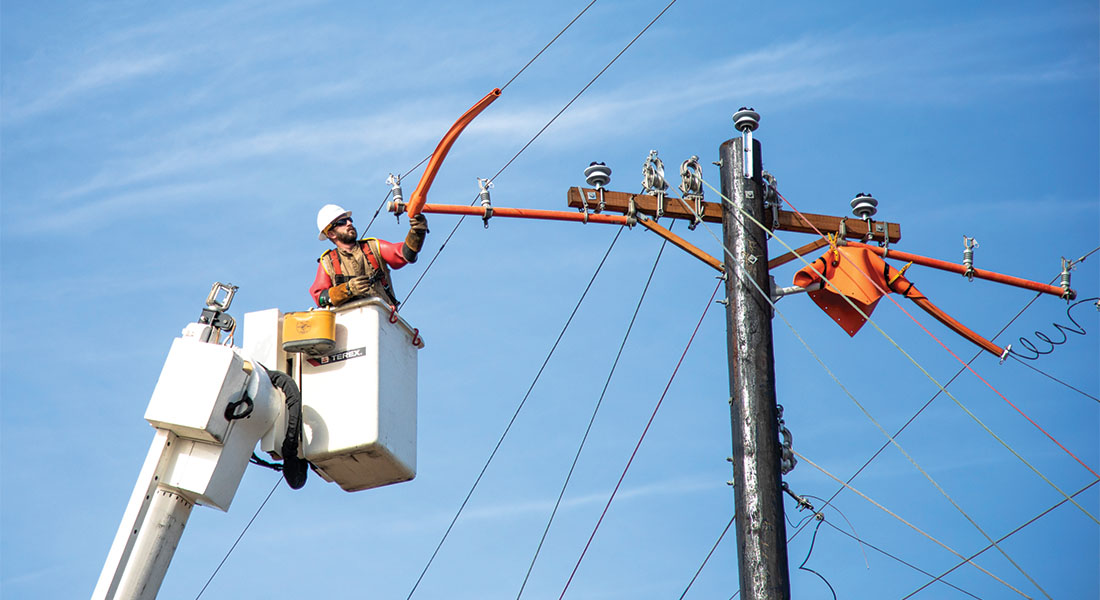 Linemen string new, high-capacity wire along U.S. 377 in Aubrey. Photo by KEN OLTMANN