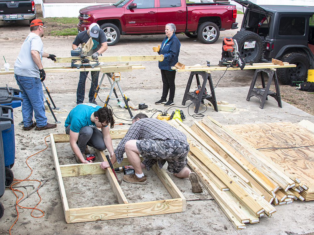 CoServ Employees build the frame for the ramp.