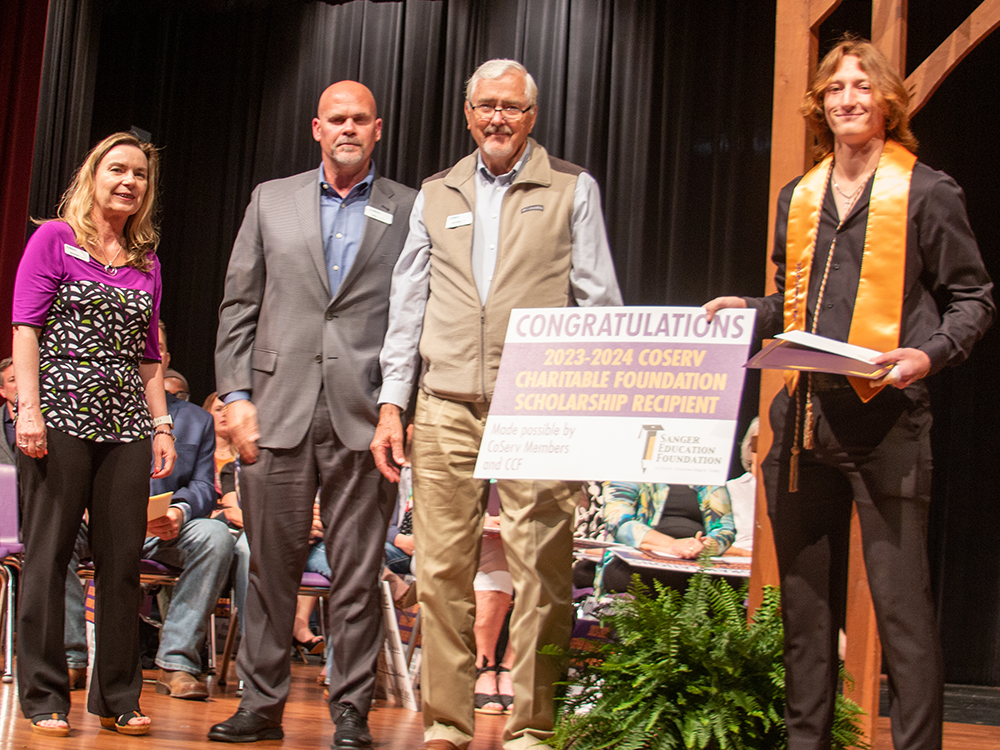 05-2023_blog_Sanger-Scholarships__4025 CCF and Outreach Coordinator Jennifer Ebert, Senior Vice President Field Operations Shea Hassell and CoServ Board District 1 Director Richard Muir present Chandler Bowland with a Sanger ISD Education Foundation scholarship that was funded by the CoServ Charitable Foundation.