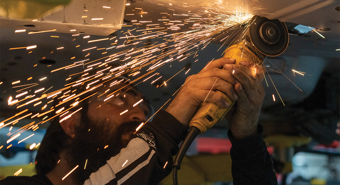 Welding Fabricator Alfonso Moreno works on a Mustang.