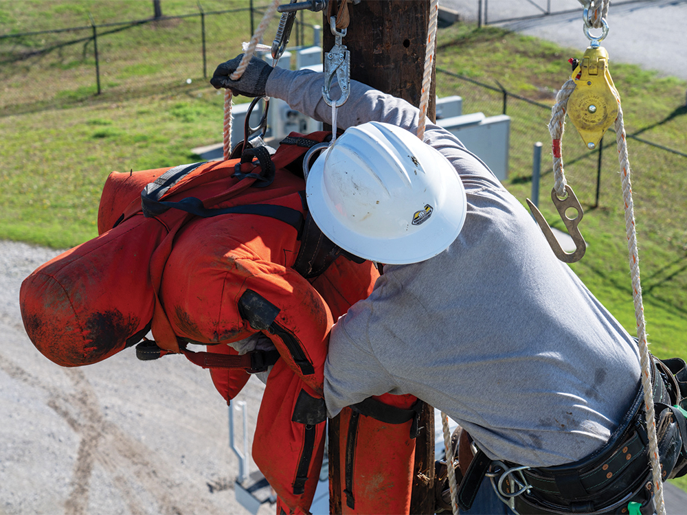 A lineman practices the hurt man rescue.
