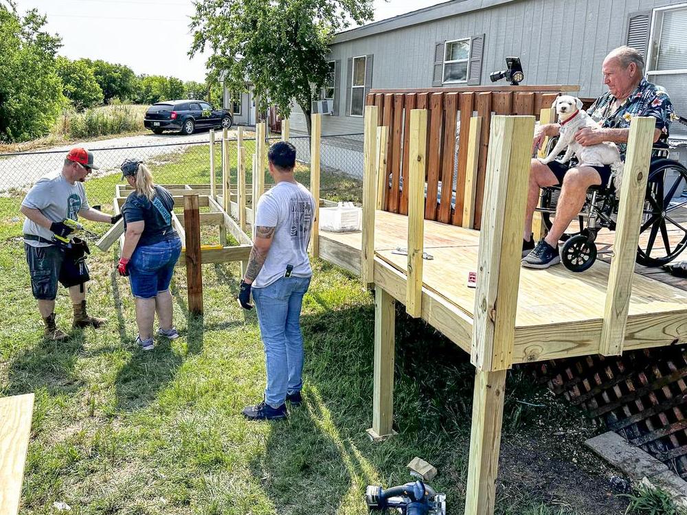 CoServ Member Jim Chastain watches CoServ Employees build a ramp for him at his home in Justin.Photo by DAN LEMONS/CoServ