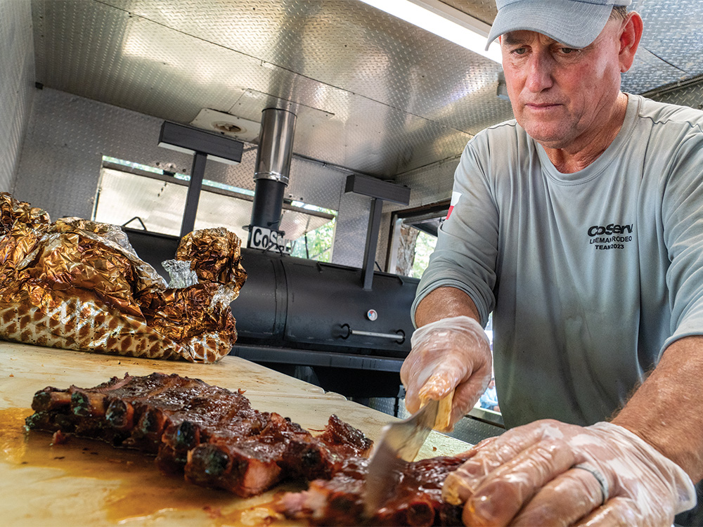 CoServ's cooking team member Jeff Richardson slices ribs for the judges.
