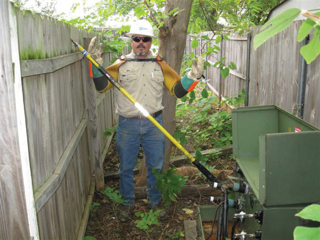 Because of the high voltage, CoServ linemen use a hotstick so they can remain a safe distance away from the transformer. This is why the area around the equipment needs to remain clear of vegetation and obstacles. 