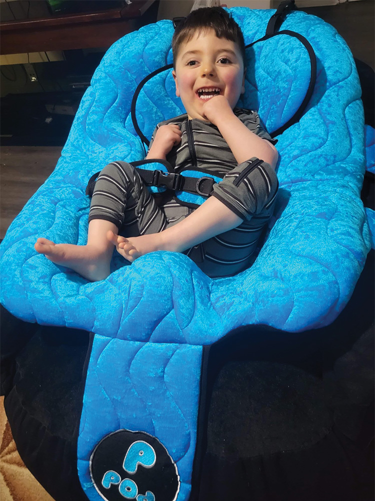 Elijah sits in his P-Pod Chair from NAF.