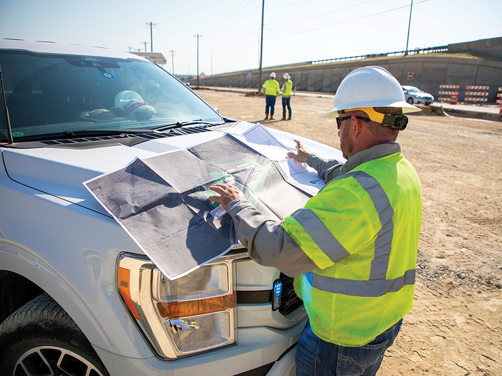 Slade Wright looks at plans at the Fields Parkway jobsite.