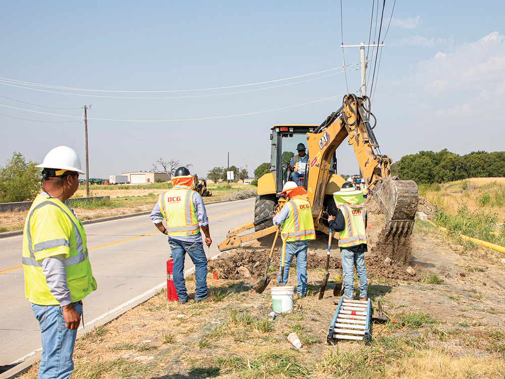 Contractors from DCG begin digging for the new natural gas line while Felipe watches.