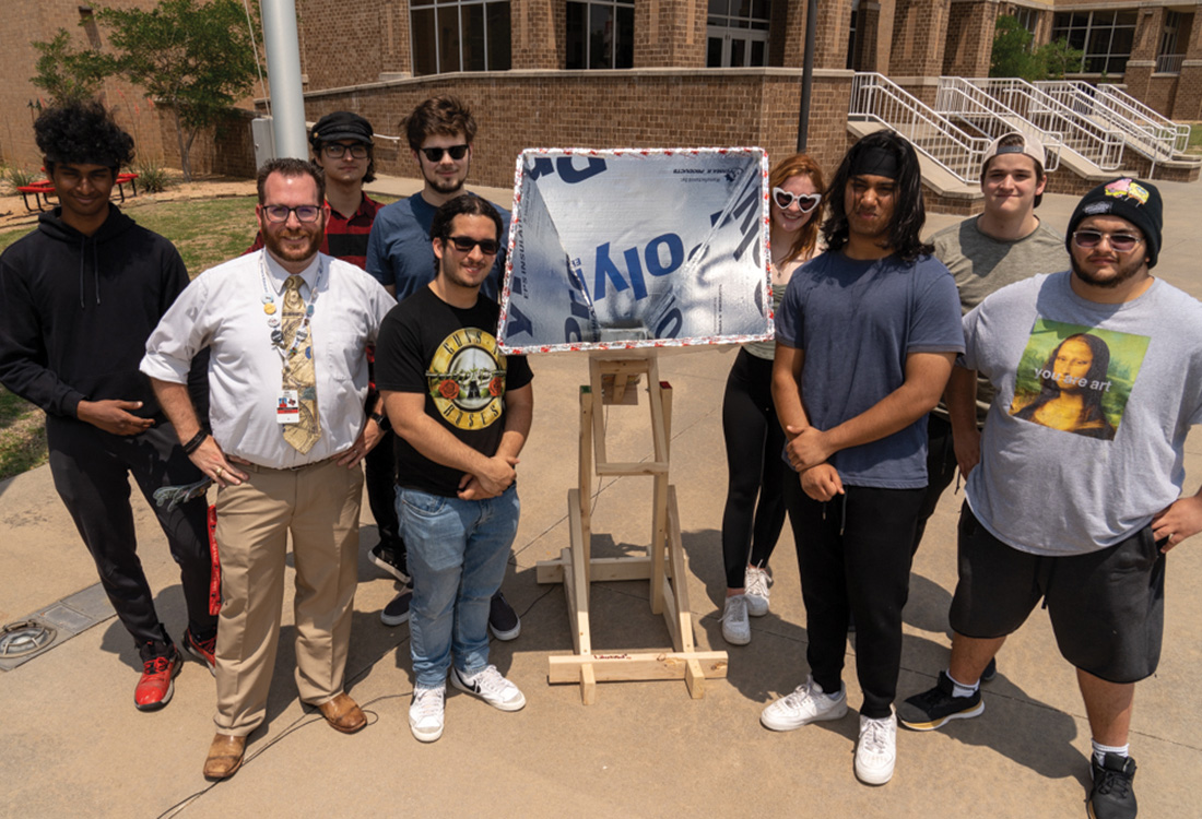 Astronomy teacher Kenric Davies poses with
his students.
