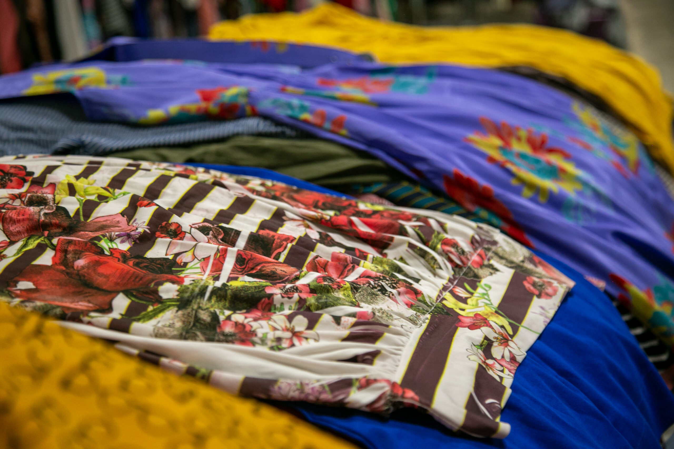 Clothes are sorted by type and size at Love Thy Neighbor.