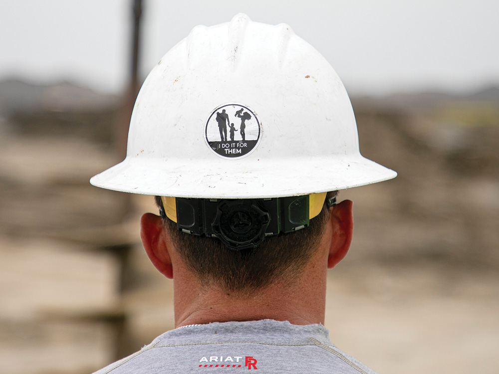 CoServ hard hats include the “I Do It For Them” logo. Photo by KEN OLTMANN