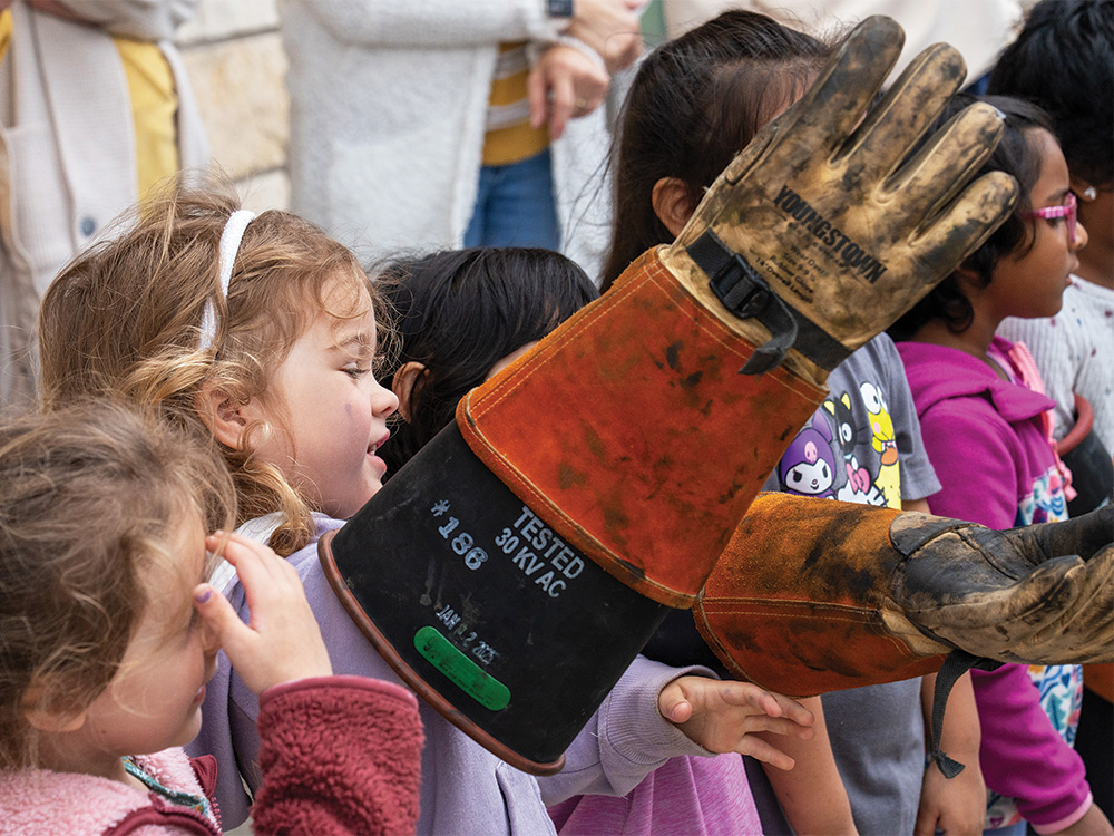 Students try on the insulated gloves.
