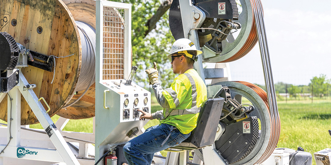 New high-capacity wire is unfurled on Brewer Road in Providence Village. Photos by KEN OLTMANN
