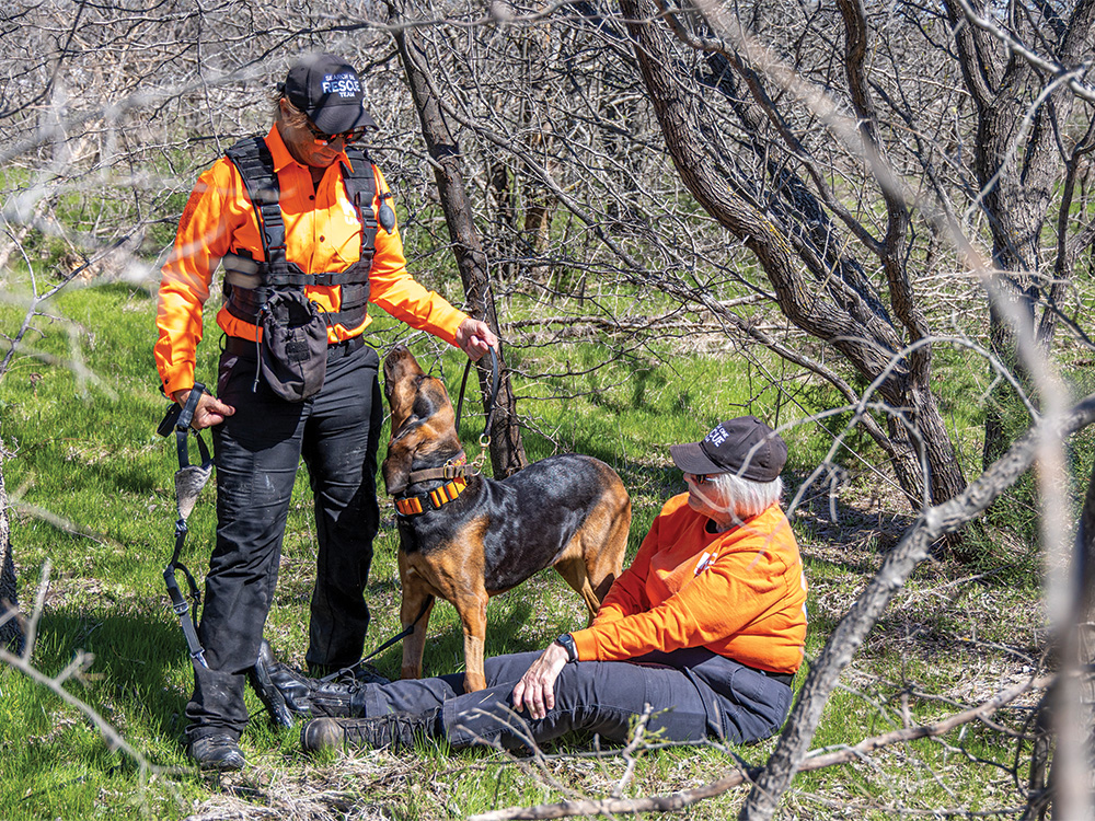 Vicki Rose and her bloodhound, Lola, followed a scent through the woods to find the “victim” in the training exercise.