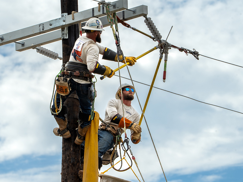 CoServ Lineman Justin Brown and Jared Day compete in the 2025 Texas Lineman Rodeo.