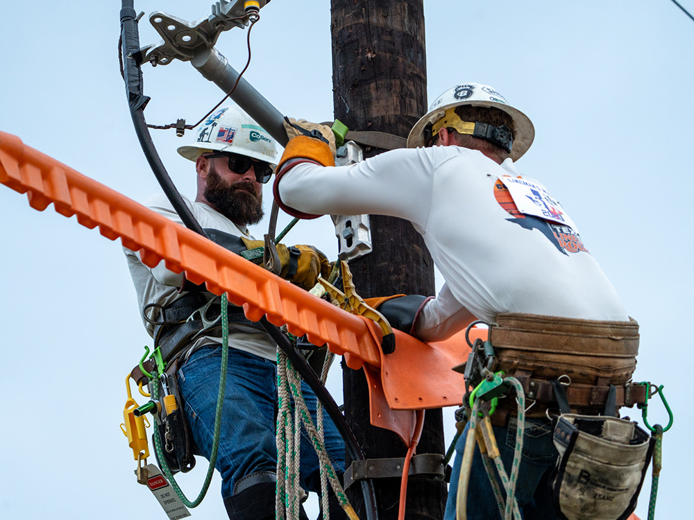 CoServ Lineman Justin Brown and Jared Day compete in the 2025 Texas Lineman Rodeo.