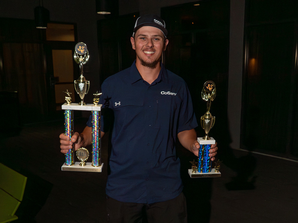 CoServ Lineman Kenny Beutter holds up his trophies from winning fourth place in the Overall Apprentice Division and fifth place in the Apprentice Division Written Test.