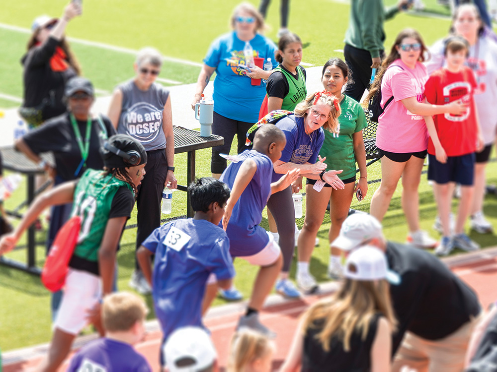 Tanya Crisp cheers on one of her students during a Special Olympics event at Lake Dallas High School earlier this year.