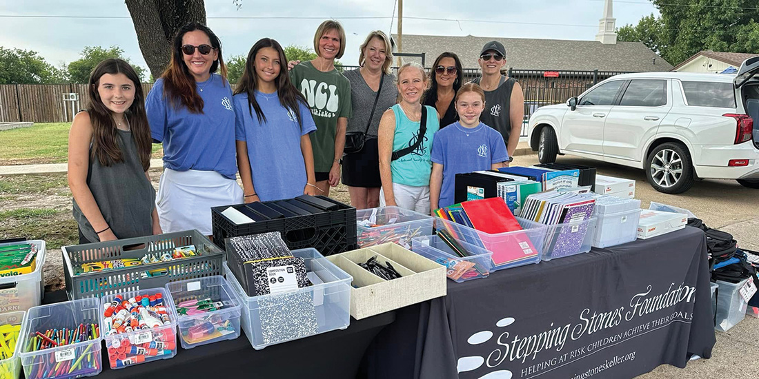 Christina Bynum-Breaux (fifth from the right) founder and board member of the Stepping Stones Foundation along with volunteers, hosts a school supply giveaway in a low-income neighborhood. Photo by STEPPING STONES FOUNDATION
