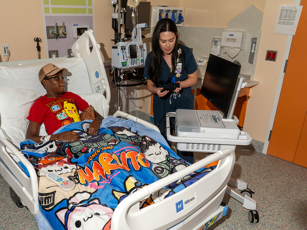 14-year-old Jackson Cole plays a game on a new PlayStation GO Kart while being treated at Cook Children's Medical Center in Prosper. The Go Kart was donated by CoServ Charitable Foundation after CCF awarded a grant to Gamers Outreach to buy the PlayStation Go Kart for kids to use while being hospitalized.