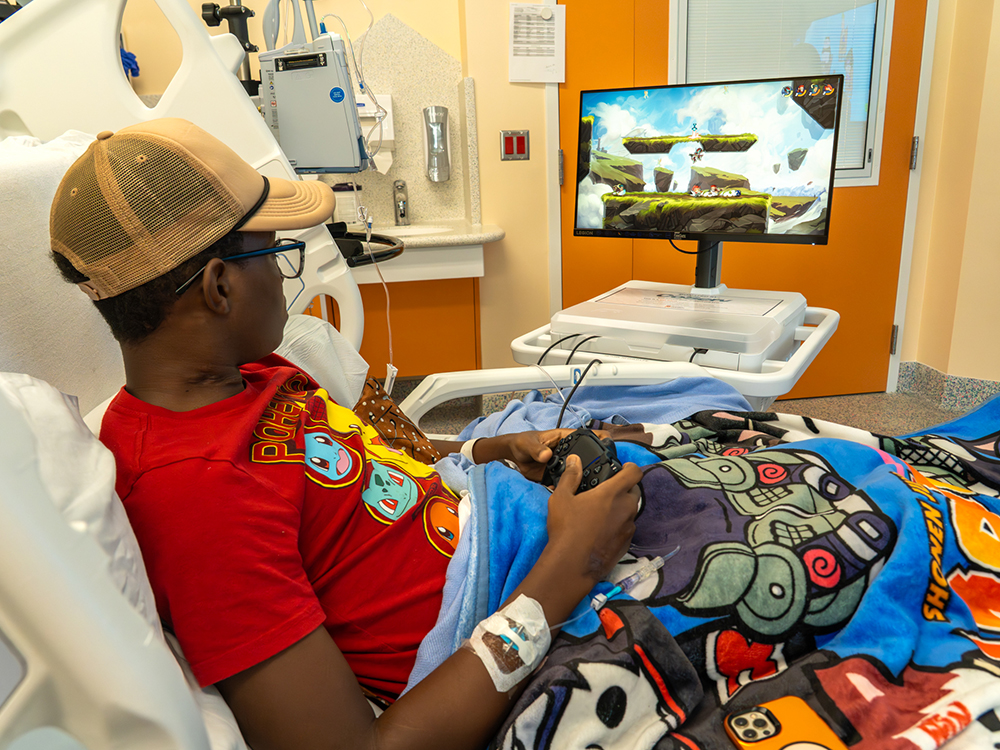 14-year-old Jackson Cole plays a game on a new PlayStation GO Kart while being treated at Cook Children's Medical Center in Prosper. The Go Kart was donated by CoServ Charitable Foundation after CCF awarded a grant to Gamers Outreach to buy the PlayStation Go Kart for kids to use while being hospitalized.