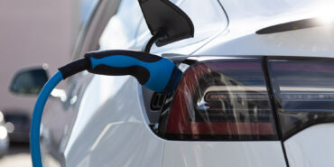 EV electric car pluged charging at a recharge station in the city