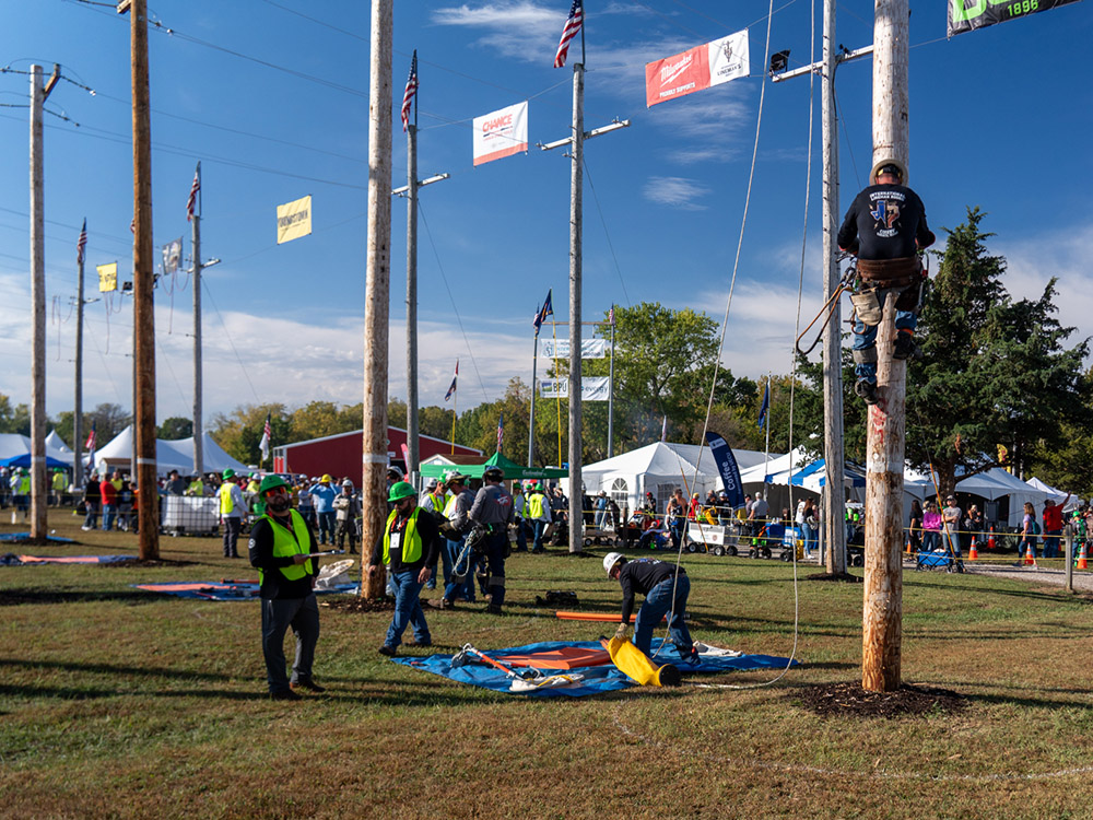 CoServ linemen climb a pole at the International Lineman Rodeo competition. 