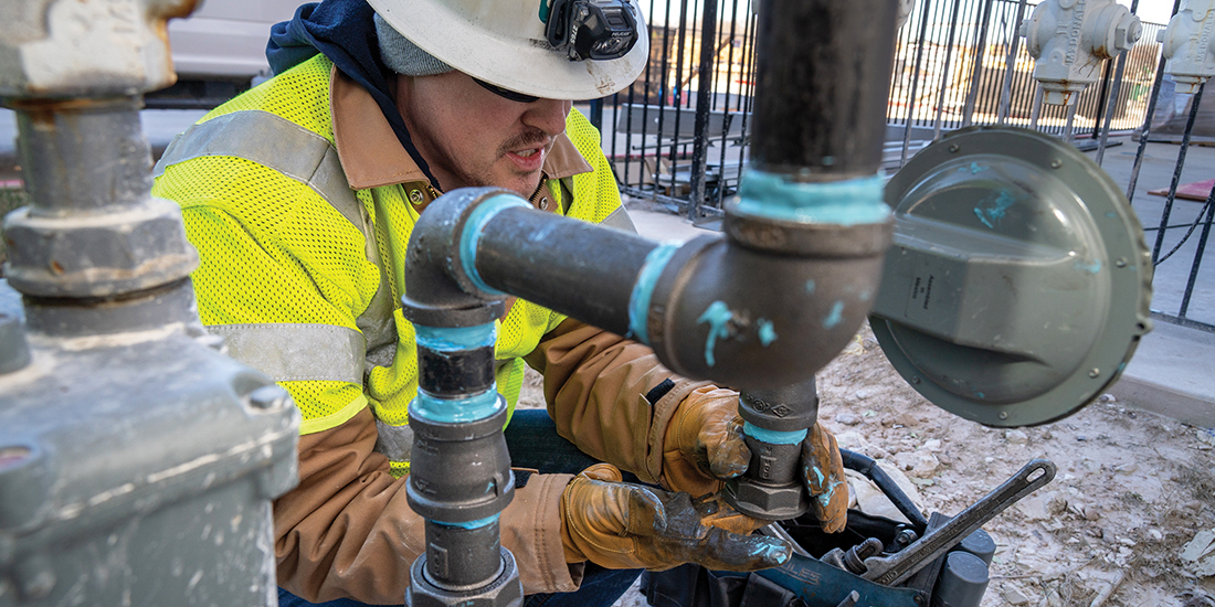 CoServ Gas Operations Field Supervisor Alex Copeland putting in a new gas meter at a business in McKinney. Photos by BRIAN ELLEDGE