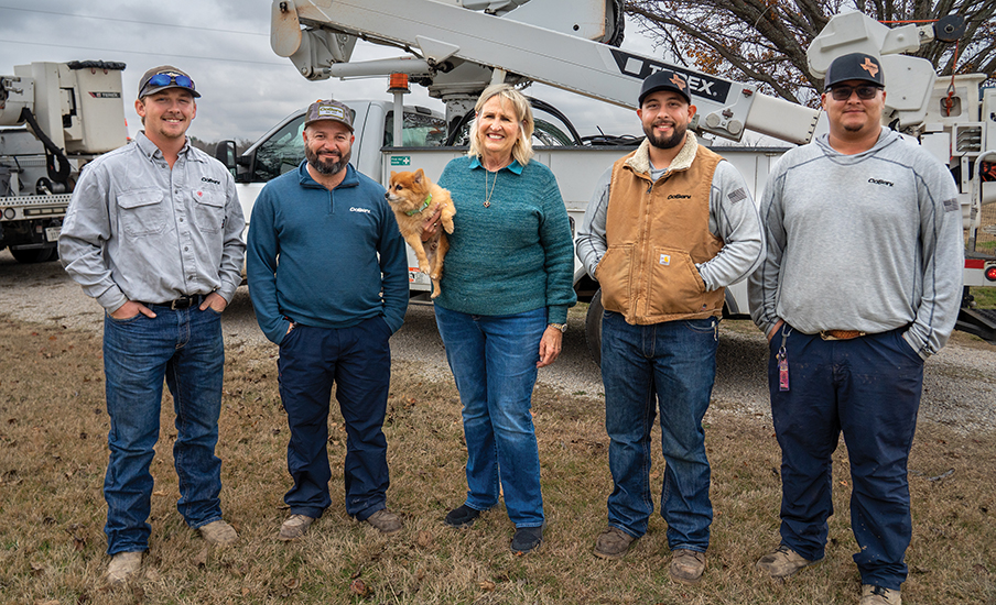 CoServ Member Jo Ann Ream meets the CoServ linemen who helped restore power to her area after a bad lightning storm last October. Pictured (L to R) Dillon Hodge, Santiago Dominguez, Jo Ann Ream, Jesse Median, Mitchell Para. Photo by BRIAN ELLEDGE