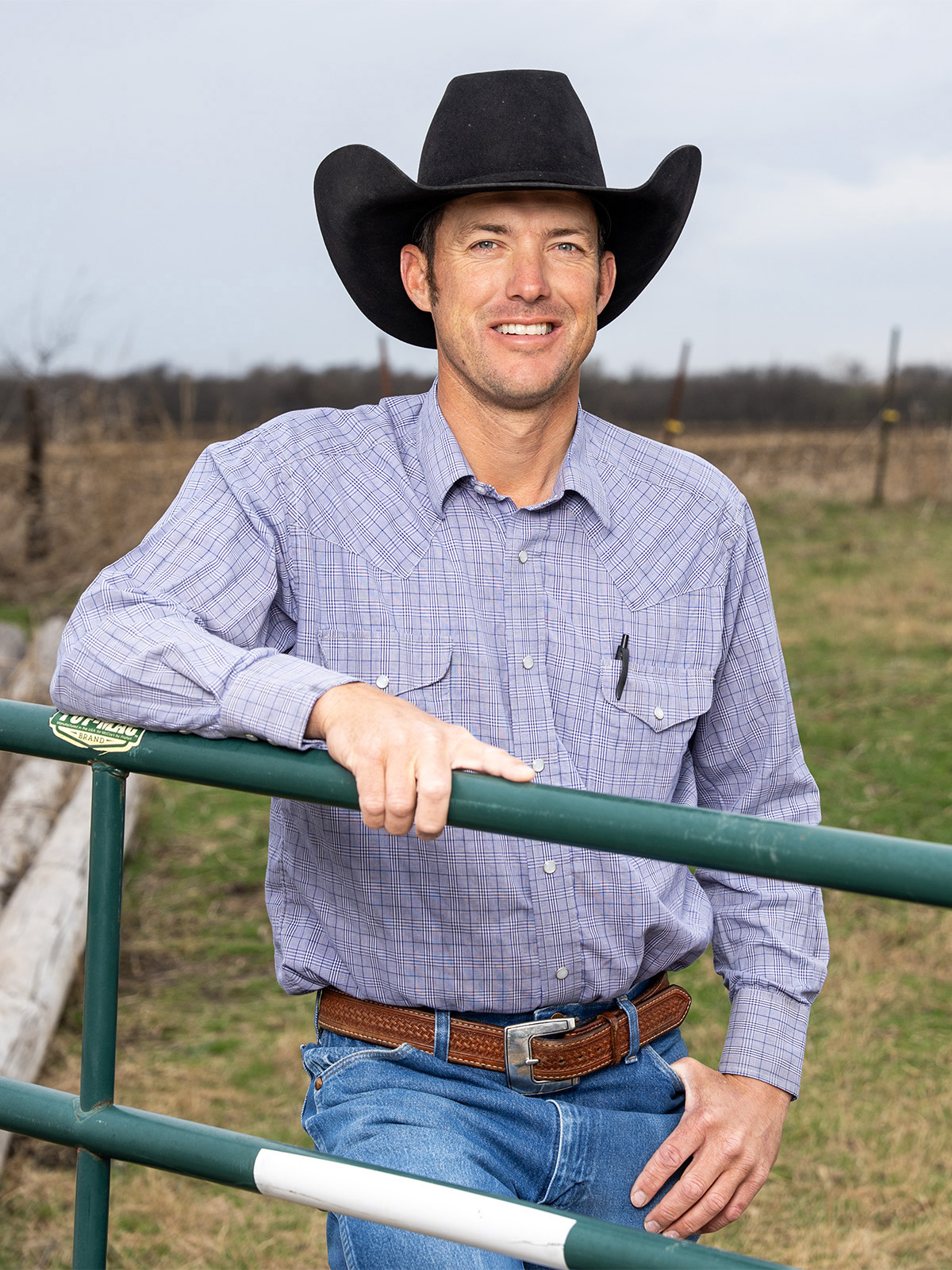 At the gate of his year‑round bull pasture, Scott Schumacher relies on CoServ’s electric hot wire to keep the herd safely contained.