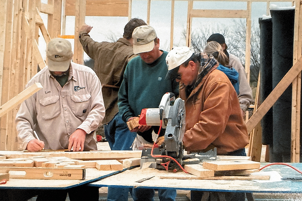 CoServ Employees work with Habitat for Humanity to build a home for a family in need. Photo by CoServ