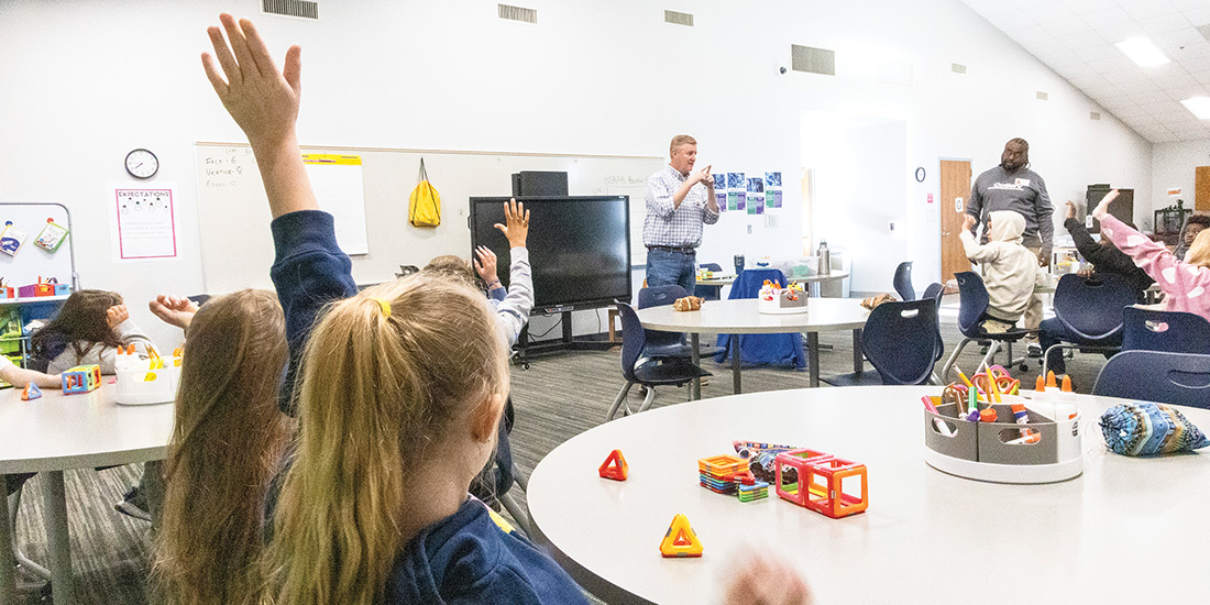 Trey Spalding and Alphonso Williams, Energy Education Specialists with CoServ, teach 2D and 3D shapes using Magnetic Builders, a CoServ-led STEM activity at the new Little Elm Elementary STEM Lab. Photo by KEN OLTMANN