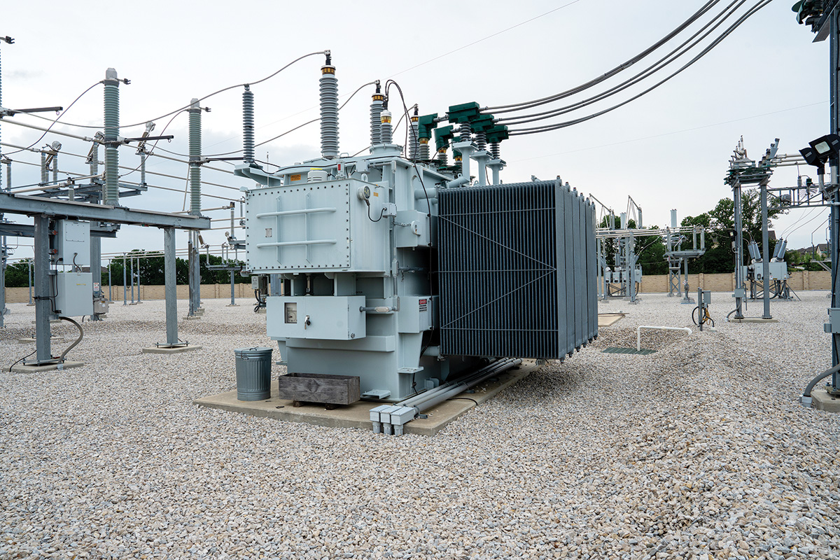 Transformers are the largest, most recognizable pieces of equipment in the substation. Substation transformers step down the voltage from high voltage (coming in on the left side) to distribution voltage (on the right side). The substation transformer area is also where the amount of electricity delivered to CoServ is measured.