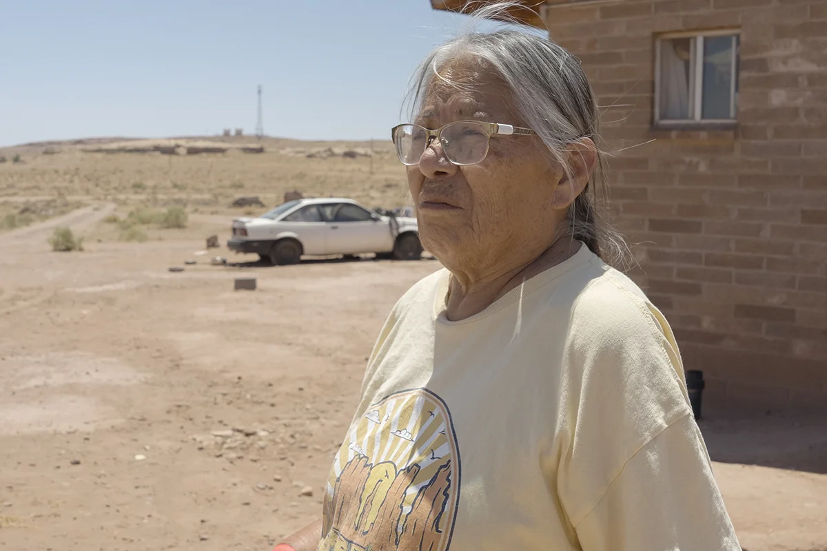 Gloria Chee, a Navajo Nation resident, stands in front of her recently electrified home.