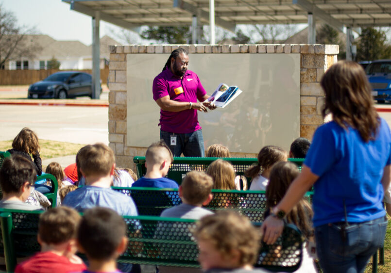 Energy Education Specialist Alphonso Williams speaks before a class of third-graders at Pilot Point Elementary school on Read Across America Day.