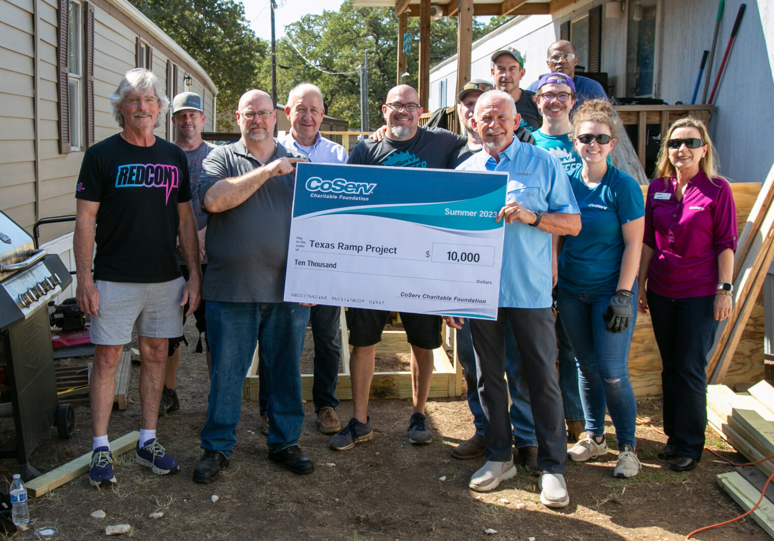 The CoServ Charitable Foundation awarded a $10,000 grant to the Texas Ramp Project to purchase materials to build 142 ramps in the CoServ electric and gas territory. The check presentation includes the homeowner, Matt Taylor, CoServ Board Director Bill Ragsdale and officials from the Texas Ramp Project.